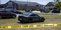 A police car parked at Appalachee High School behind police tape