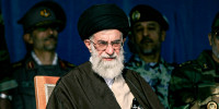 Ayatollah Ali Khamenei on a stage with army personnel.