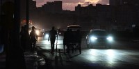 People transit on a street without power during a nation wide blackout in Havana on March 21, 2026. A power outage struck the entire island of Cuba on March 21, 2026, the energy ministry said, in the second nationwide blackout in less than a week as its grid struggles under a U.S. oil blockade.