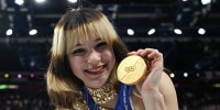 Alysa Liu poses with her gold medal in Milan on Feb. 19, 2026. 