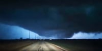 A large funnel cloud illuminated by lightning in Fairview, Okla., on Thursday.