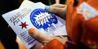Kat Abughazaleh holds a "I Voted" sticker, close up on the hands holding the sticker