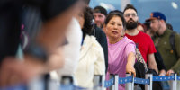 People wait in line for TSA.