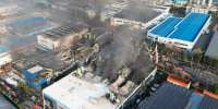 Firefighters spray water to extinguish a fire at a car parts plant in Daejeon on March 20.