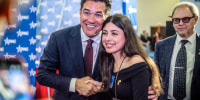 Former television actor Dean Cain poses with an attendee at CPAC in Grapevine, Texas on March 26, 2026.