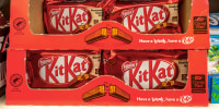 A box of KitKat bars on a shelf.