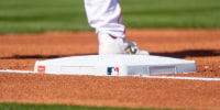 Feb 24, 2026; Tempe, Arizona, USA; Los Angeles Angels A general view of the MLB logo and first base during the first inning of a spring training game between the San Francisco Giants and Los Angeles Angels at Tempe Diablo Stadium. Mandatory Credit: Allan Henry-Imagn Images