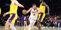 LOS ANGELES, CALIFORNIA - MARCH 14: Nikola Jokic #15 of the Denver Nuggets dribbles into the defense of Deandre Ayton #5 of the Los Angeles Lakers during the second half of a game at Crypto.com Arena on March 14, 2026 in Los Angeles, California. (Photo by Sean M. Haffey/Getty Images)