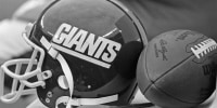 EAST RUTHERFORD, NJ - DECEMBER 15: (EDITORS NOTE: Image has been shot in black and white. Color version not available.) A view of a helmet of the New York Giants and a football on the bench before a game between the Giants and New Orleans Saints at Giants Stadium on December 15, 1984 in East Rutherford, New Jersey. The Saints defeated the Giants 10-3. (Photo by George Gojkovich/Getty Images)