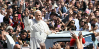 Pope Leo XIV waves to the crowd from the popemobile after the Easter Mass as part of the Holy Week celebrations, at St Peter's square in the Vatican on April 5.