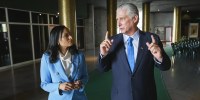 Kristen Welker and Miguel Díaz-Canel speak to each other while walking inside of a building