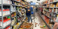 Image: Broken items scattered across the grocery store aisle floor