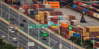Traffic Moves Past Container Yard Near Yantian Port In Shenzhen