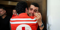 Colleagues of Red Cross paramedic Hassan Badawi, who was killed in an Israeli strike on Sunday, mourn following his funeral, in Bechamoun