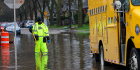 A worker with the Milwaukee Department of Public Works unclogs a storm drain.