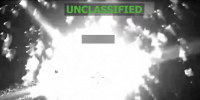 A grainy black-and-white surveillance image of an explosion that says UNCLASSIFIED across the top. 