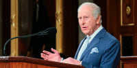 King Charles speaks at a podium