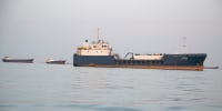 Ships are anchored near the shoreline on April 22 in Bandar Abbas, Iran as the Strait of Hormuz remains closed.
