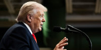 Donald Trump speaks into a microphone