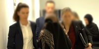 Two women charged with crimes against humanity offences allegedly committed in Syria, are pictured after being arrested on arrival into Melbourne, Australia.
