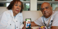 Cynthia and Nelson Wells, Sr. with a photo of Nelson, Sr. and their son Nelson Wells, Jr., who’s been imprisoned in China since 2014, in their home in Haughton, La. 