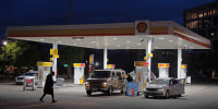 A person walks past a gas station on Wednesday, May 6, 2026, in Portland, Ore.