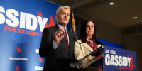 Image: Sen. Bill Cassidy, R-La., left, speaks to supporters alongside his wife, Laura, during an election night watch party.