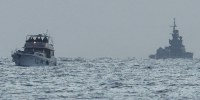 A boat bearing symbols of one of the vessels belonging to the Gaza-bound aid flotilla (L) and intercepted by the Israeli navy in international waters.
