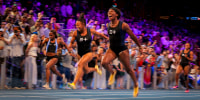 Barbados Tristan Evelyn cheers as she wins the women's 100m next to Jamaica's Denae McFarlane and US's Shania Collins.