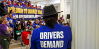 Uber and Lyft drivers at a rally inside the Massachusetts State House.