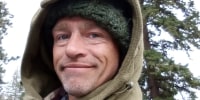 A selfie of Matt Brown with a knitted cap and a hood pulled up.