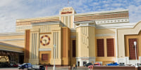 The exterior of South Point Casino, painted yellow walls and red accents