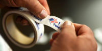Loren Book, an election official at the McFarland Lake Park Conservation Center polling place in Ames, Iowa, tears an "I Voted" stickers off a roll for voters on Election Day, Tuesday, Nov. 5, 2024, in Ames. 