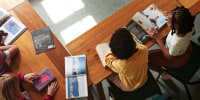 High angle view of students reading books