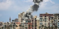 A big plume of smoke rises from a building