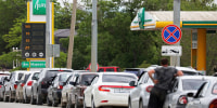 Cars queue for fuel at a gas station in Saki