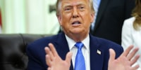 Donald Trump gesturing with both hands while seated in the Oval Office.