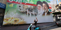 A man flashes the victory sign in front of a billboard depicting the late Iranian leader Ayatollah Ali Khamenei and Iranian Supreme Leader Ayatollah Mojtaba Khamenei in Beirut, Lebanon, on June 15, 2026. 