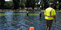 Image: National Park Service workers and contractors use vacuums to remove algae from the bottom of the Lincoln Memorial Reflecting Pool on June 20, 2026, in Washington, D.C. 