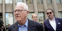Frank stronach, outside a courthouse.