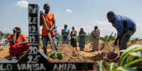 Relatives of Vanisa Anifa, a 6-month-old orphaned girl who died of Ebola, attend her burial.