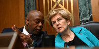 Senators Tim Scott (R) and Elizabeth Warren (D) speak during a confirmation hearing in Washington.