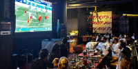 Iranian fans watch their national team's World Cup match against Belgium at Viking Cafe in Tehran on Sunday.