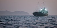 A ship anchored off Port Sultan Qaboos on June 21, 2026 in Muscat, Oman, as the pace of the reopening of the Strait of Hormuz remained unclear.