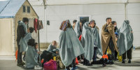 Migrants seen sheltering in the first aid camp