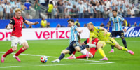 Lionel Messi of Argentina shoots to score his second goal against Austria