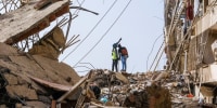 People search through debris.