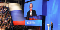 Image: Vladimir Putin on stage addressing an audience