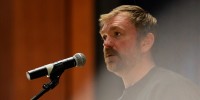 Graham Platner speaks into a microphone
