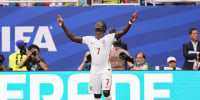 Bukayo Saka celebrating on the pitch during a world cup match.